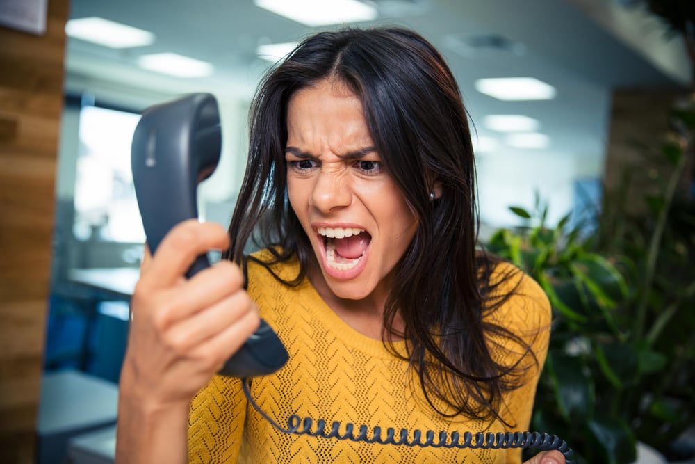 Angry businesswoman shouting on phone in office-1